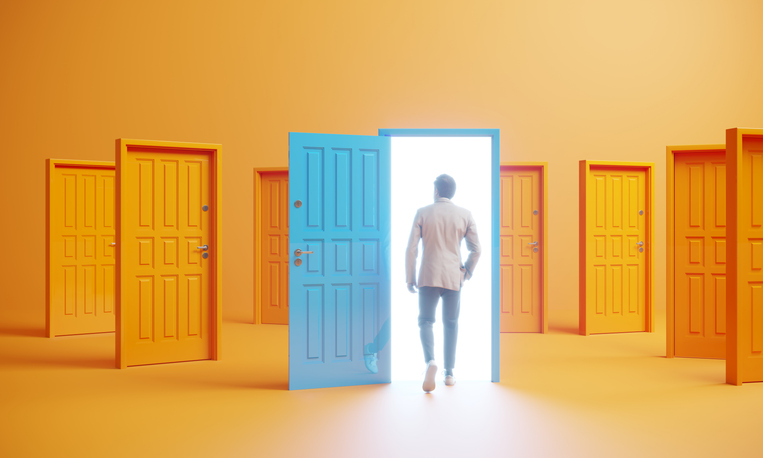 Man with multiple door options walking through a blue open door.