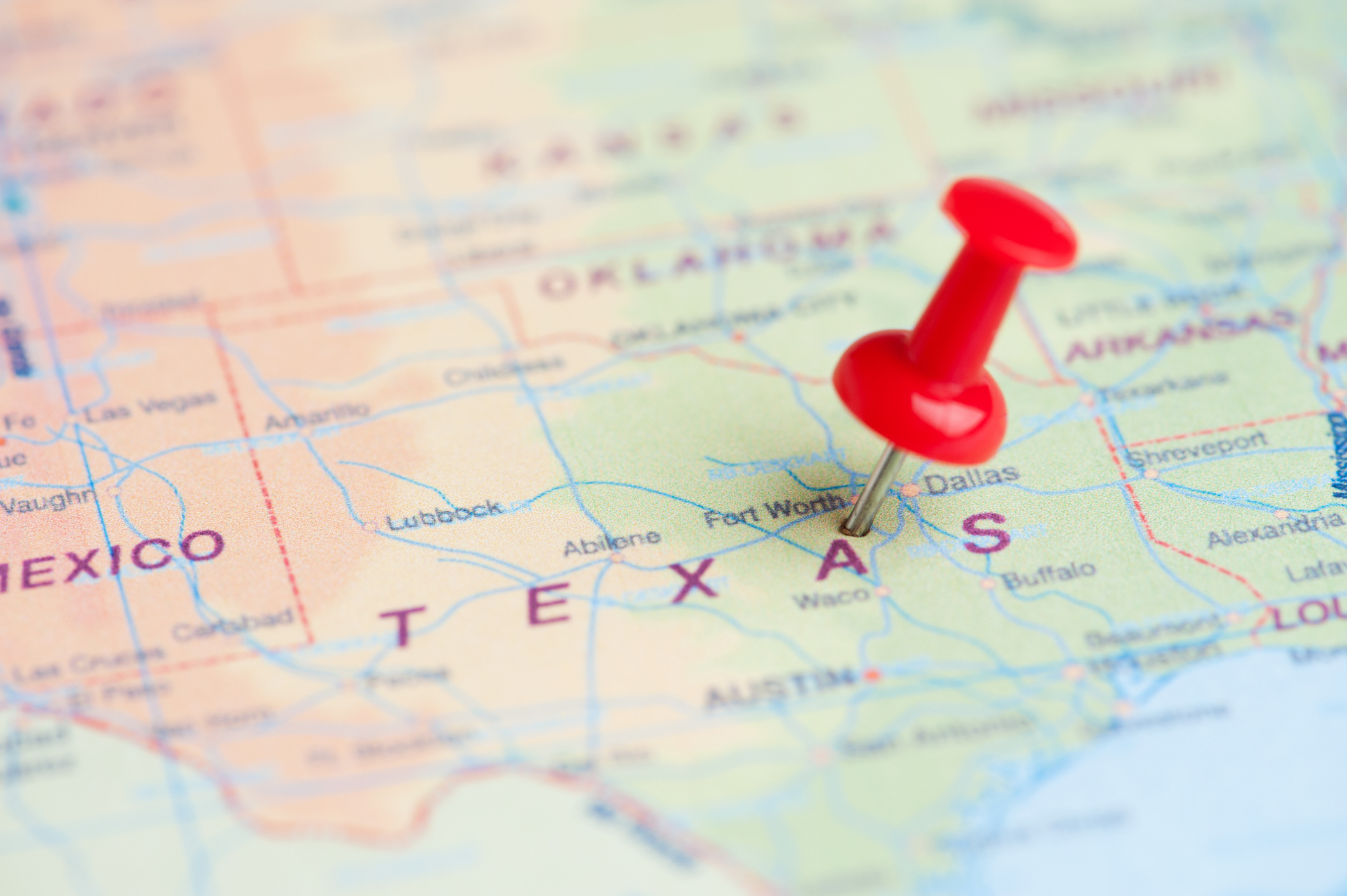 Texas map with thumbtack.